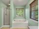 Bright bathroom featuring shower and tub, with window that lets in natural light at 206 Hawkridge Pl, Goose Creek, SC 29445
