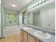 Fresh bathroom featuring a double sink vanity, soaking tub, and large window at 206 Hawkridge Pl, Goose Creek, SC 29445