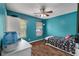 Comfortable teal bedroom featuring a ceiling fan, dresser, and natural light at 206 Hawkridge Pl, Goose Creek, SC 29445