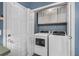 Laundry area featuring new washer and dryer units and ample storage inside the white cabinet at 206 Hawkridge Pl, Goose Creek, SC 29445
