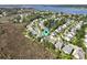 Aerial shot of a neighborhood with pond and water access, surrounded by greenery at 2141 Sandy Point Ln, Mount Pleasant, SC 29466