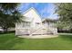 Landscaped backyard of home featuring a screened-in porch and stone patio at 2141 Sandy Point Ln, Mount Pleasant, SC 29466