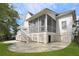 Backyard featuring a screened-in porch, a stone patio, and stairs to the yard at 2141 Sandy Point Ln, Mount Pleasant, SC 29466
