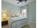 Bright bedroom showcasing a queen bed, two bedside tables with lamps, and fresh decor at 2141 Sandy Point Ln, Mount Pleasant, SC 29466