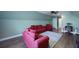 Comfortable bonus room with wood flooring, a ceiling fan, and red seating arrangement at 2141 Sandy Point Ln, Mount Pleasant, SC 29466