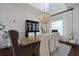 Bright dining room showcasing a wood table, white chairs, and a modern chandelier at 2141 Sandy Point Ln, Mount Pleasant, SC 29466
