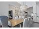 Bright dining room showcasing a wood table, white chairs, and an elegant chandelier at 2141 Sandy Point Ln, Mount Pleasant, SC 29466