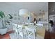 Open dining space featuring a modern chandelier, natural light and view to kitchen at 2141 Sandy Point Ln, Mount Pleasant, SC 29466