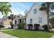Charming two-story white home featuring a welcoming front porch and lush green lawn at 2141 Sandy Point Ln, Mount Pleasant, SC 29466