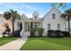 Charming two-story white home featuring a beautifully landscaped yard and inviting front porch at 2141 Sandy Point Ln, Mount Pleasant, SC 29466