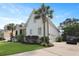 Home with a well-manicured lawn, driveway, and lush landscaping at 2141 Sandy Point Ln, Mount Pleasant, SC 29466