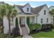 Charming home with a well-manicured lawn, a cozy front porch, and lush landscaping at 2141 Sandy Point Ln, Mount Pleasant, SC 29466