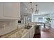 Kitchen view showcasing tile backsplash and open flow to dining and living room at 2141 Sandy Point Ln, Mount Pleasant, SC 29466