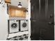 Functional laundry room equipped with modern appliances, ample cabinet space, and stylish flooring at 2141 Sandy Point Ln, Mount Pleasant, SC 29466