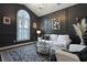 Stylish living room with dark walls, complemented by a white sofa and patterned rug at 2141 Sandy Point Ln, Mount Pleasant, SC 29466