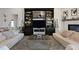 Stylish living room with wood floors, a built-in entertainment center, and comfortable seating at 2141 Sandy Point Ln, Mount Pleasant, SC 29466