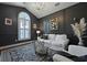 Stylish living room with dark walls, complemented by a white sofa and patterned rug at 2141 Sandy Point Ln, Mount Pleasant, SC 29466