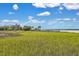 Picturesque marsh view showcasing the waterfront property, home, and long pier at 2141 Sandy Point Ln, Mount Pleasant, SC 29466