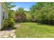 A well-maintained lawn with a lush border of trees and bushes in the private backyard at 2184 Tall Grass Cir, Mount Pleasant, SC 29466