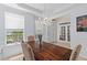 Bright dining room showcasing a wood table, chandelier, and window views at 2184 Tall Grass Cir, Mount Pleasant, SC 29466