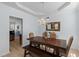 Elegant dining room with a rustic wood table, upholstered chairs, and a decorative chandelier at 2184 Tall Grass Cir, Mount Pleasant, SC 29466
