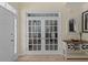 Bright foyer featuring french doors, neutral tones, and a decorative console table with stylish accents at 2184 Tall Grass Cir, Mount Pleasant, SC 29466