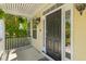 The front door is framed by sidelights, decorative molding, and complemented by hanging ferns on a covered porch at 2184 Tall Grass Cir, Mount Pleasant, SC 29466