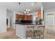 Modern kitchen with dark countertops, wood cabinets, stainless appliances, and two-chair breakfast bar at 2184 Tall Grass Cir, Mount Pleasant, SC 29466