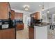Modern kitchen with dark countertops, wood cabinets, stainless appliances and breakfast bar at 2184 Tall Grass Cir, Mount Pleasant, SC 29466