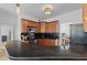 Modern kitchen with dark countertops, wood cabinets, stainless appliances, and breakfast bar seating at 2184 Tall Grass Cir, Mount Pleasant, SC 29466