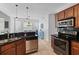Modern kitchen with dark countertops, wood cabinets, stainless appliances, and open layout at 2184 Tall Grass Cir, Mount Pleasant, SC 29466