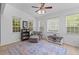 Bright living room with seating area, ceiling fan, wood flooring, and natural light at 2184 Tall Grass Cir, Mount Pleasant, SC 29466