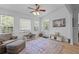 Comfortable living room with seating area, ceiling fan, wood flooring, and natural light at 2184 Tall Grass Cir, Mount Pleasant, SC 29466