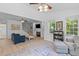 Bright living room with blue sofa, wood floors, ceiling fans, fireplace and comfortable seating at 2184 Tall Grass Cir, Mount Pleasant, SC 29466
