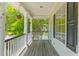 View of the covered porch with white railings and potted plants at 2184 Tall Grass Cir, Mount Pleasant, SC 29466