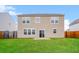 A green backyard features a two-story house with tan siding and a patio at 241 Wathen Dr, Goose Creek, SC 29445