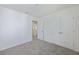 Bedroom featuring neutral carpet, white walls, a closet, and view to hall at 278 Catawba Branch Way, Moncks Corner, SC 29461