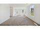 Bright and airy living room with neutral walls, plush carpeting, and multiple windows at 278 Catawba Branch Way, Moncks Corner, SC 29461