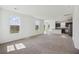 Spacious living room with abundant natural light, neutral carpet, and an open-concept design at 278 Catawba Branch Way, Moncks Corner, SC 29461