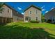 A charming home featuring a well-maintained backyard with lush green grass and a view of the home's exterior at 286 Chemistry Cir, Ladson, SC 29456