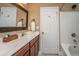 A well-lit bathroom with a wide mirror, sink, and shower at 286 Chemistry Cir, Ladson, SC 29456