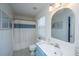 Bright bathroom featuring blue vanity, neutral tile floors and a large mirror at 286 Chemistry Cir, Ladson, SC 29456