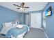 Cozy bedroom with a ceiling fan, wall-mounted television, and comfortable bed at 286 Chemistry Cir, Ladson, SC 29456