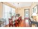 Well-lit dining room with a dark wooden table, chandelier, and large window at 286 Chemistry Cir, Ladson, SC 29456
