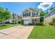 Charming two-story home featuring manicured lawn, gray siding and an inviting front porch with a US flag at 286 Chemistry Cir, Ladson, SC 29456