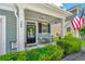 Inviting front porch featuring a small table, potted plants, and an American flag, creating a cozy entrance at 286 Chemistry Cir, Ladson, SC 29456
