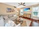Cozy living room featuring a comfortable gray sectional sofa, hardwood floors, and a large screen TV at 286 Chemistry Cir, Ladson, SC 29456