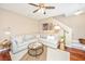 Inviting living room featuring a gray sectional sofa, hardwood floors, and staircase access at 286 Chemistry Cir, Ladson, SC 29456