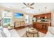 Open concept living room and kitchen featuring hardwood floors, a gray sectional sofa, and a kitchen island at 286 Chemistry Cir, Ladson, SC 29456