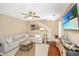 Inviting living room featuring a gray sectional sofa, hardwood floors, and a large screen TV at 286 Chemistry Cir, Ladson, SC 29456